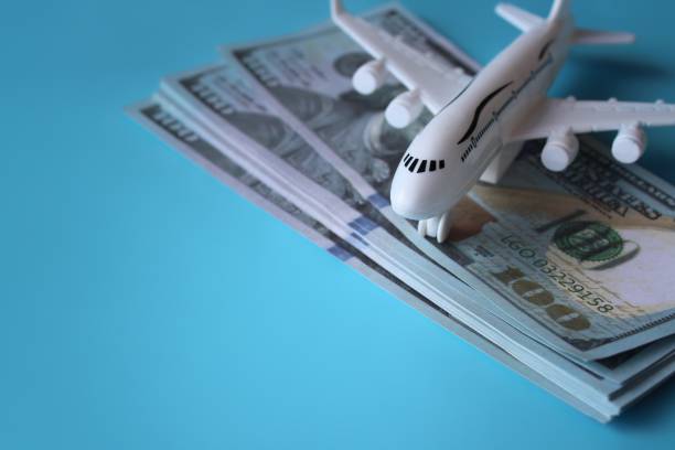 istock Toy plane and money on blue background 1461281386