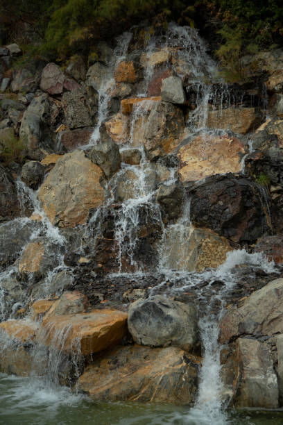 istock Vertical shot of a waterfall between the rocks in the forest 1461281479