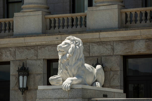 Lion statues in front of the building of courthouse in Sofia, blue sky on the background. Old city classical court palace in soviet architecture style, entrance decorated with lion sculptures