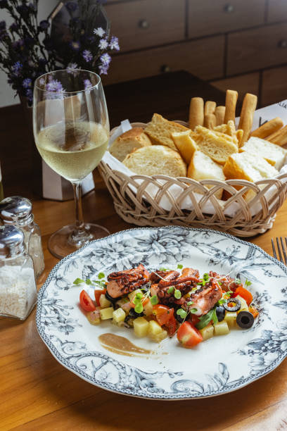 istock Octopus with vegetables, white wine, and fresh bread served at the restaurant 1461281491