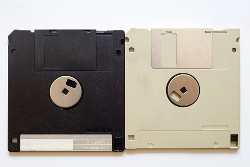 A closeup shot of floppy discs on a white isolated background