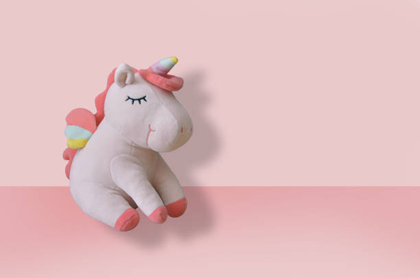 istock Cute soft unicorn plush toy on pink background. Close up shot, empty space 1461283284