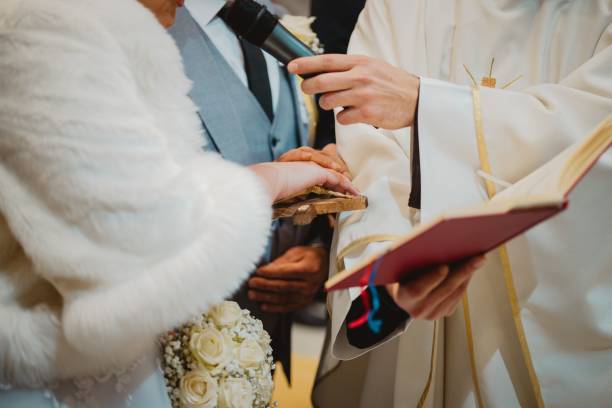 istock Groom and bride standing in front of a priest during their wedding ceremony 1461283371