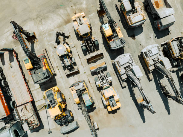 Aerial View of Industrial Equipment and Excavator on Industrial Place. Aerial View of Industrial Equipment and Excavator on Industrial Place. Construction site top view. Shooting from the drone. construction equipment stock pictures, royalty-free photos & images