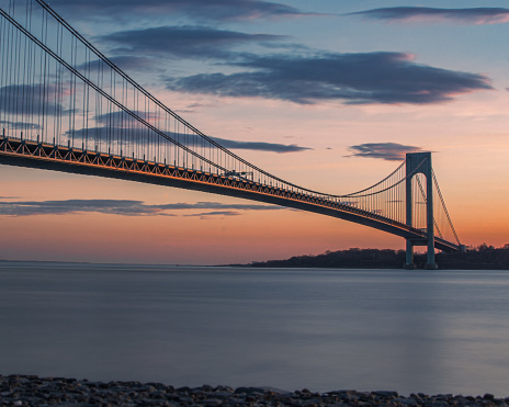 A scenic shot of the Verrazzano-Narrows suspension Bridge during the colorful sunset in New York