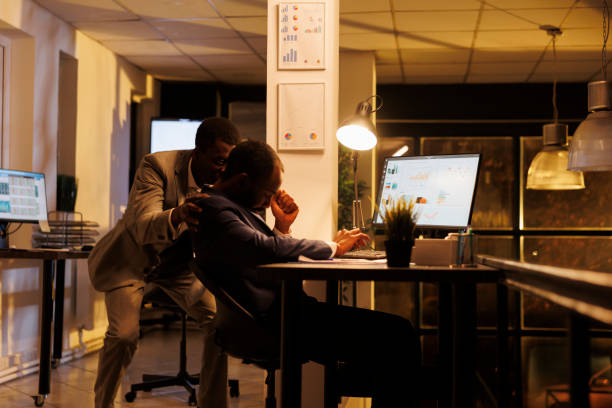istock Businessman wakes up worker after falling asleep on table 1461288055