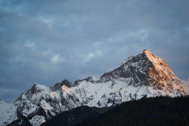 istock Rocky mountain covered with snow against cloudy sky in Austria 1461294543