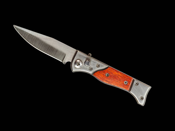 istock Pocket folding knife with wooden handle isolated on black 1461294698