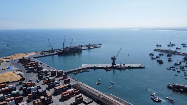 istock Drone shot of objects and cargo shops on a harbor under the blue sky 1461298206