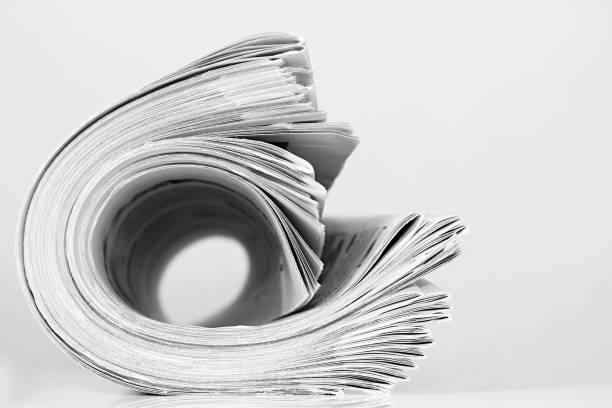 istock Greyscale of stack of newspapers isolated on a white background 1461298771