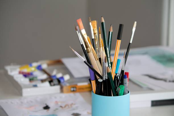 istock Pencil and paint brush on a container bowl 1461298814
