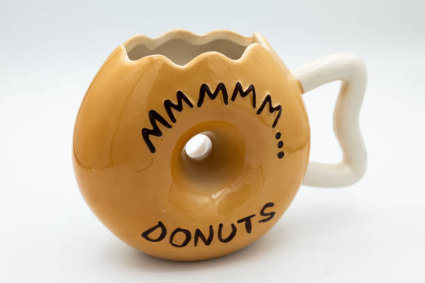 A close-up shot of a cute donut-shaped mug isolated on a white background