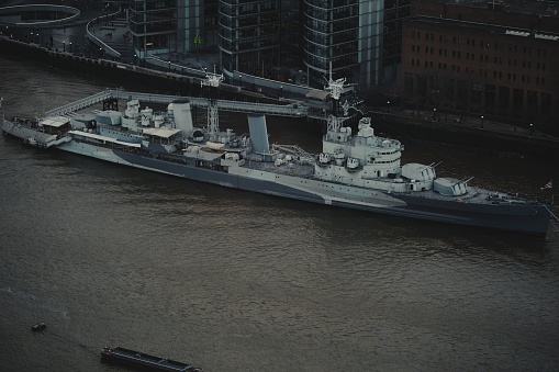 london, United Kingdom – January 01, 2023: A high angle shot of the HMS Belfast warship cruising on the River Thames in London, England