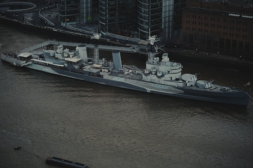 Navy frigate enters a harbour after offshore training exercises.