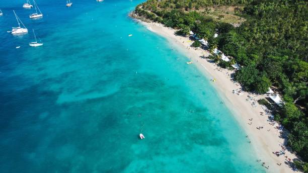 istock Aerial shot over a blue beach with boats 1461299772
