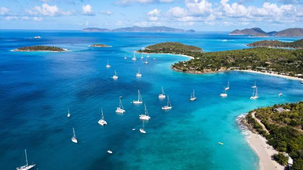 istock Aerial shot over a blue beach with boats 1461299773