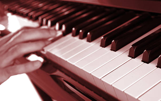 istock Hands playing music on piano 1461299837