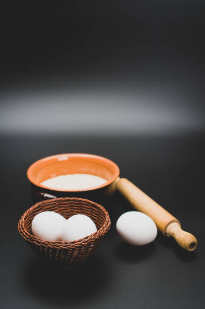 istock rustic terracotta bowl with flour and white eggs on a black tabletop 1461301501