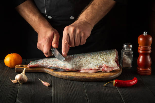 istock The chef cuts the fish before cooking. Working environment in the restaurant kitchen. Fish diet concept 1461301801