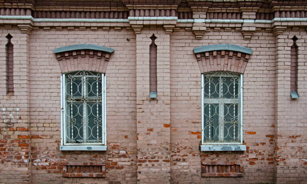 istock Old building facade with a brick wall and latticed windows 1461305104