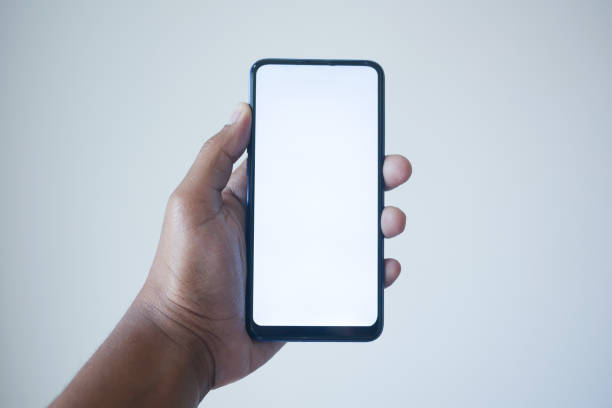 istock POV of young man hand using smart phone with white screen 1461305132