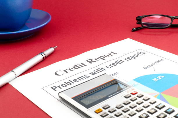 istock Credit report on the red table and a pen. 1461306321