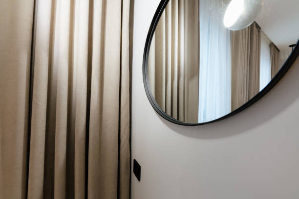 istock a large round mirror in a black frame on the wall 1461307073