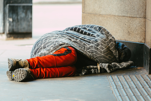 London, UK - 31 January, 2023: a homeless person sleeping rough on the street near Leicester Square in central London, UK.