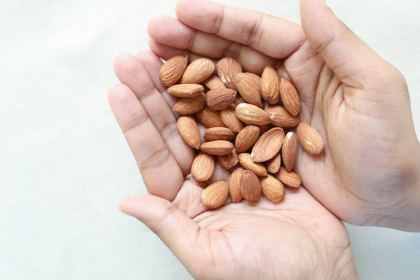 istock close up of almond nuts on man's hand 1461311479