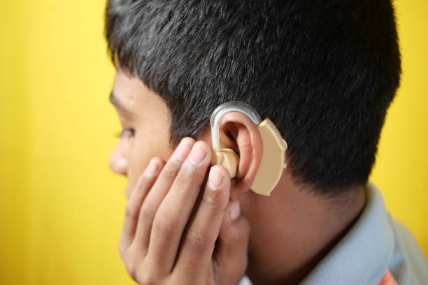 istock Hearing aid concept, teenage boy with hearing problems. 1461311512