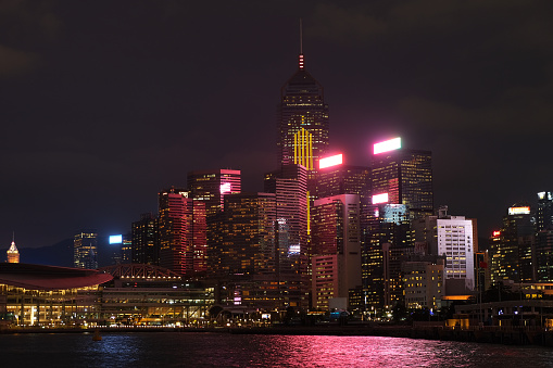 Wan Chai district skyline on Victoria Harbour at night, Hong Kong island.