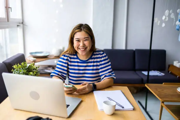 Young woman sitting at desk working on laptop