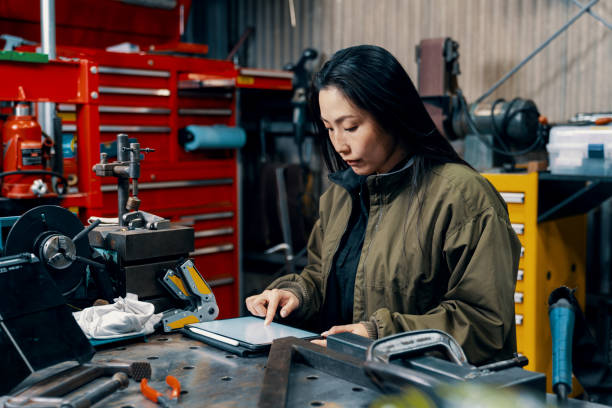istock Mid adult female using a digital tablet in a metal fabrication workshop 1461316826