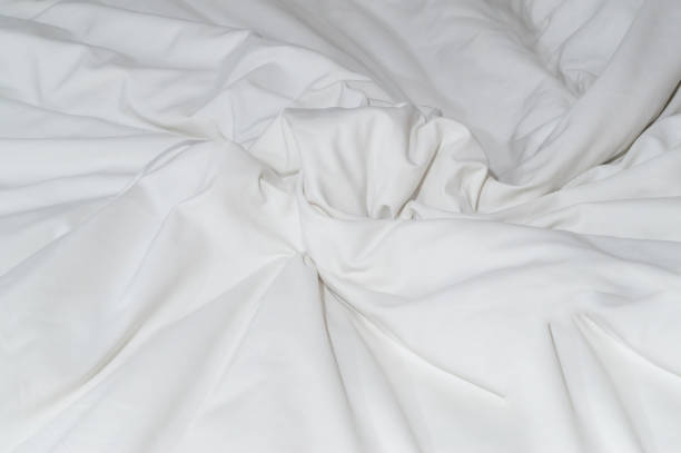 istock White crumpled or wrinkled bedding sheet or blanket with pattern after guest's use taken in hotel, resort room with copy space, Untidy blanket background texture 1461316847