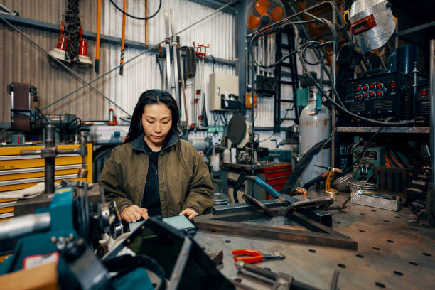 istock Mid adult female using a digital tablet in a metal fabrication workshop 1461316908