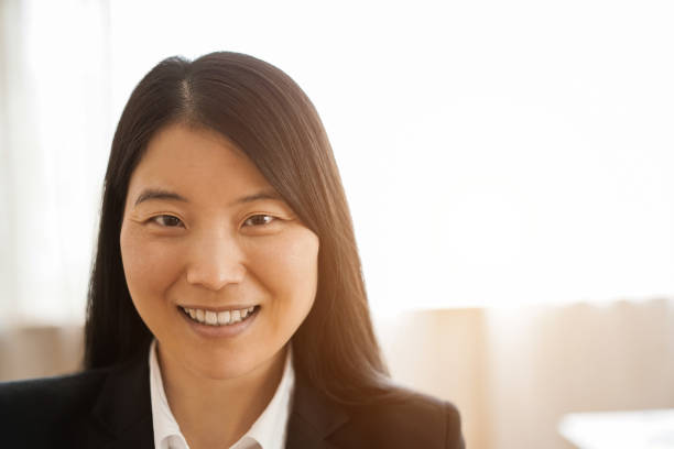 istock Asian young woman smiling on camera inside modern office 1461317376