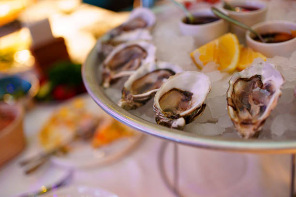 istock shells with oysters on a platter with ice, lemons and sauce. 1461318623