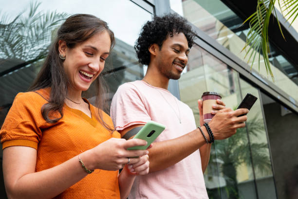 istock happy friends using mobile phone for fun in coffee shop 1461318629