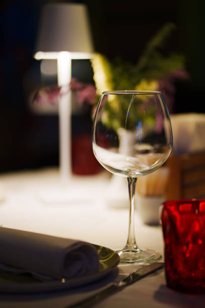 istock a table with a white tablecloth, glasses, crockery and decor in dark restaurant 1461321325