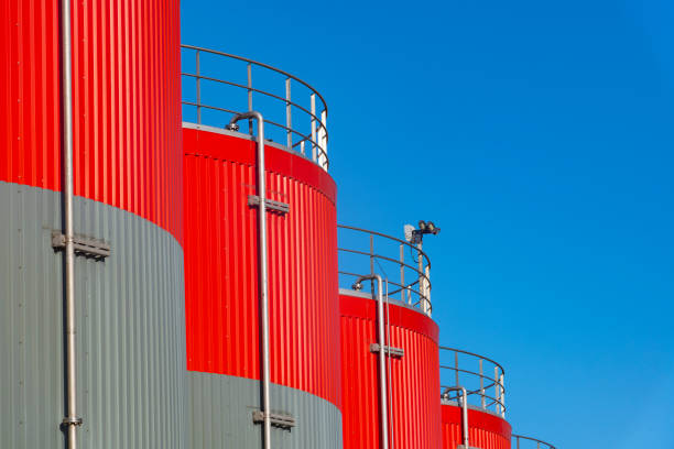istock Industrial storage tanks in grey and red close up 1461322561