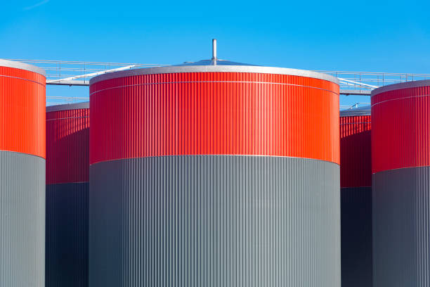 istock Industrial storage tanks in grey and red close up 1461322584