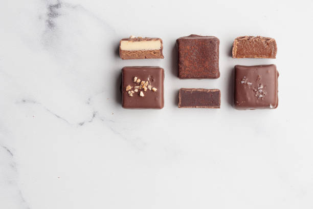 istock Chocolate bonbons with praline on white marble background 1461326799