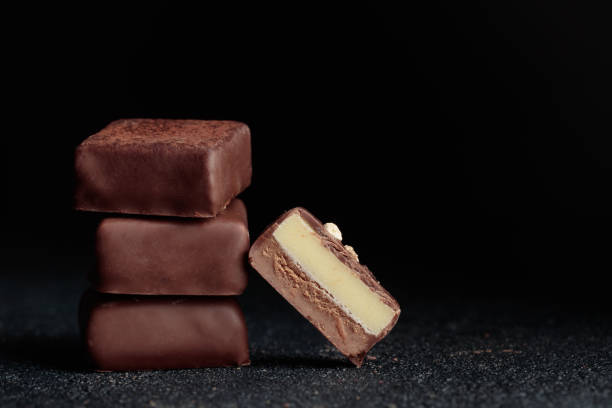 istock Chocolate bonbons with praline on black background 1461326907