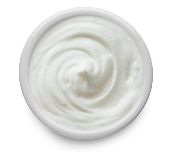 istock Yoghurt is swirled around in white bowl on white background. Clipping path. 1461328392