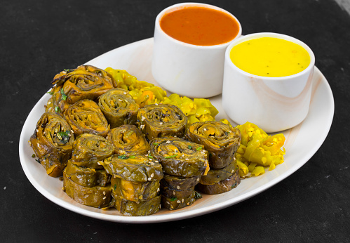Indian Spicy Food Patra Also Called Paatra, Alu Vadi or Patrode is a Veg Dish in Maharashtra or Gujarati Cuisine. It is Made from Colocasia Leaves Stuffed with Rice Flour And Spices, Tamarind, Jaggery
