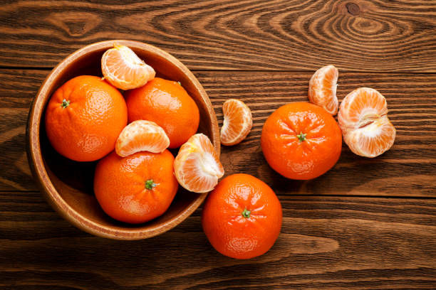 istock Tangerines close-up on a wooden background. Top view 1461331027