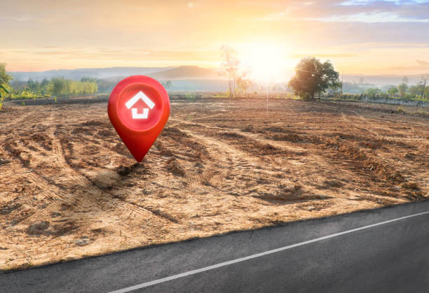 istock House symbol with location pin and Empty dry cracked swamp reclamation soil, land plot for housing construction project with and beautiful sunset sky with fresh air Land for sales landscape concept 1461335310
