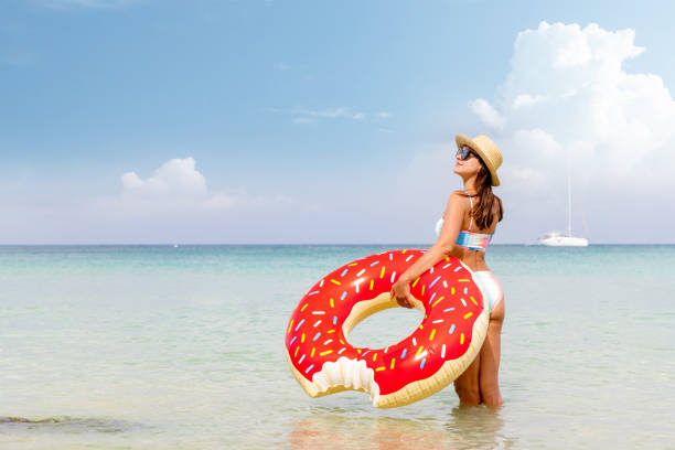 istock Beautiful woman with inflatable donut 1461336319