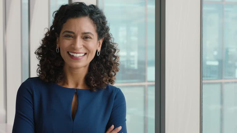 portrait confident business woman smiling with arms crossed successful female office executive enjoying career in corporate leadership company manager at work