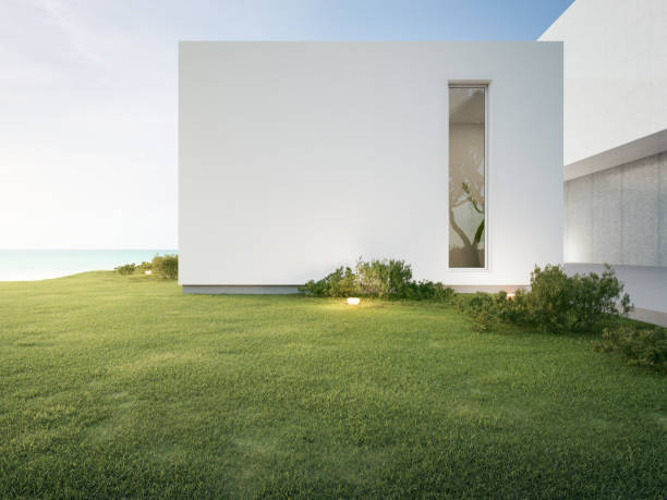 Exterior house architectural design. Elite cluster housing with modern and minimalist house model design. Car garage and small garden in front of the house building. Quiet and comfortable family home. Semarang, Indonesia.